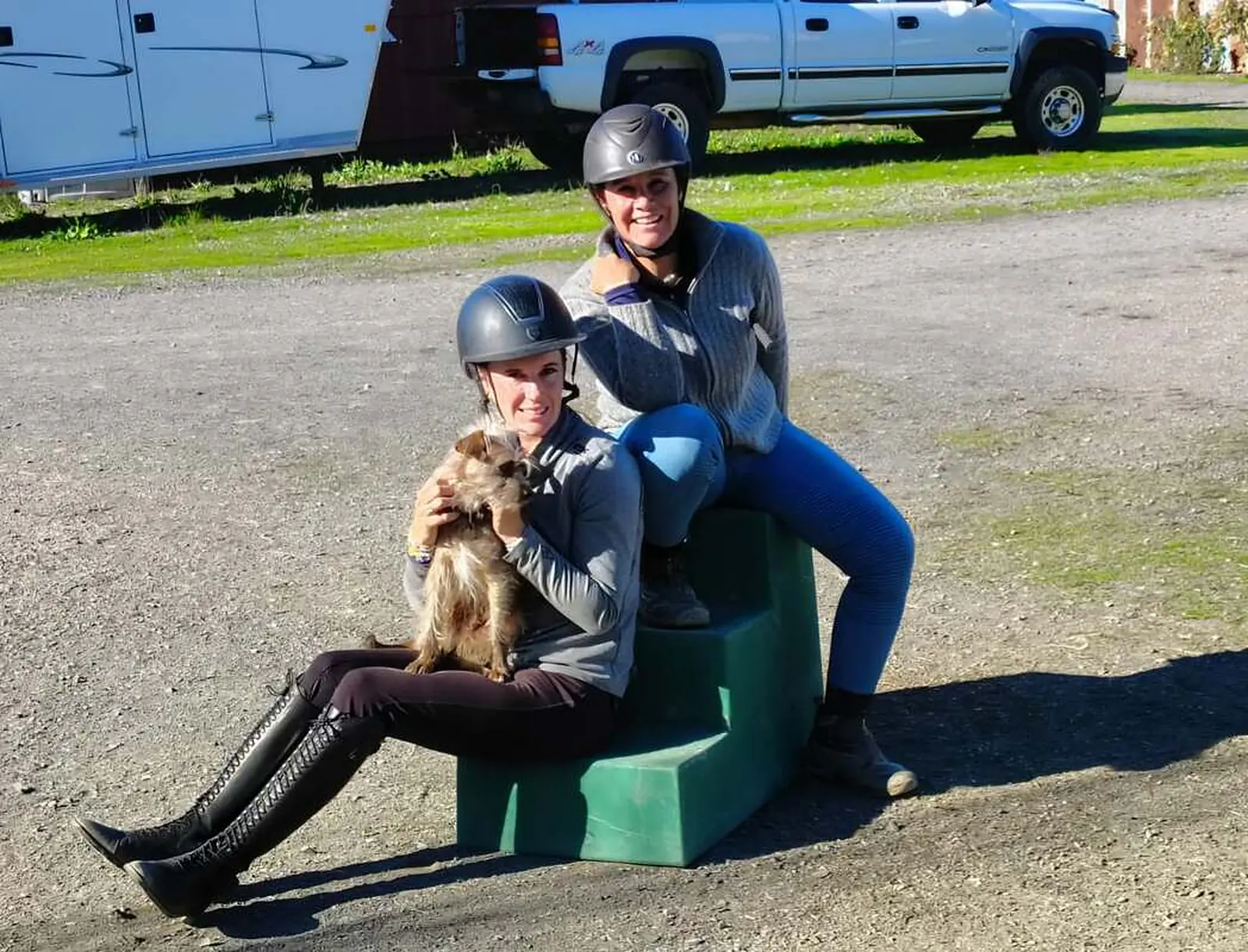 Tressa Boulden and Paloma David seated together with a dog