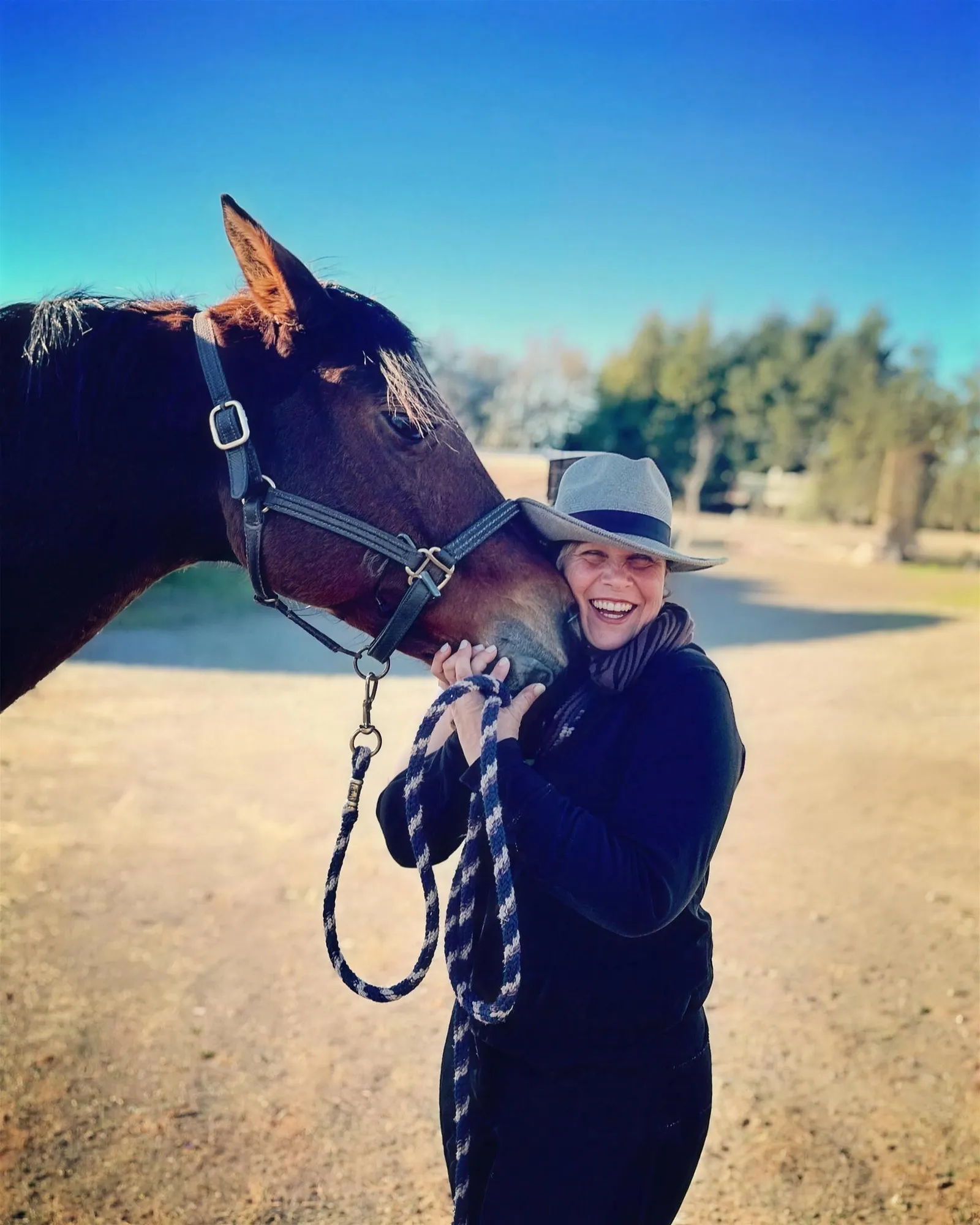 Tressa Boulden with her mare Allura being nuzzled